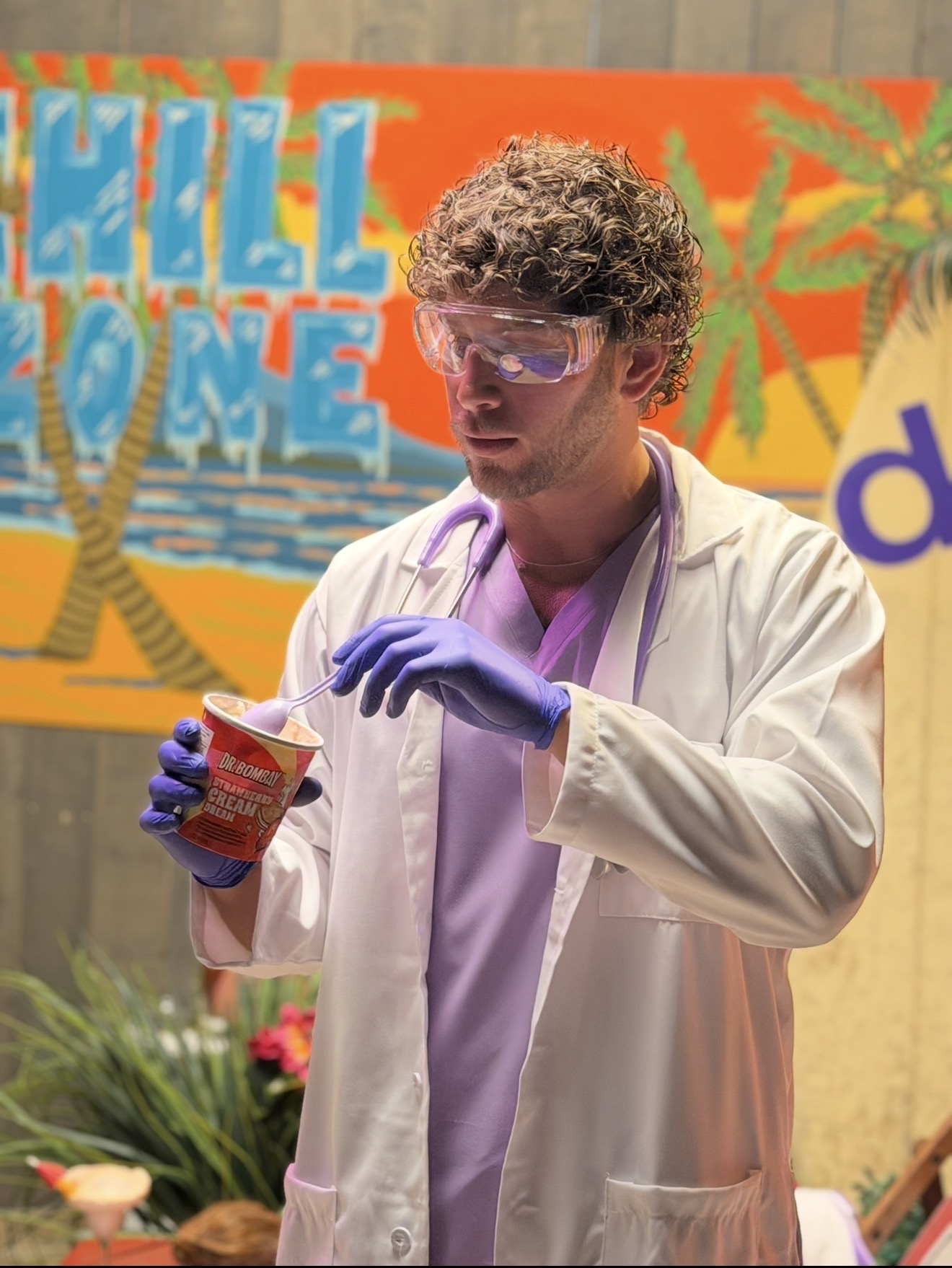 Creator tasting Dr. Bombay ice cream on the tropical set